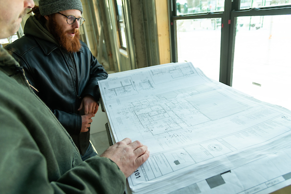 Two men looking at blueprints