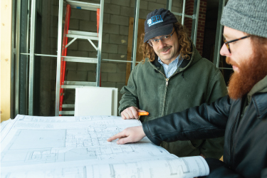 Two men looking at blueprints